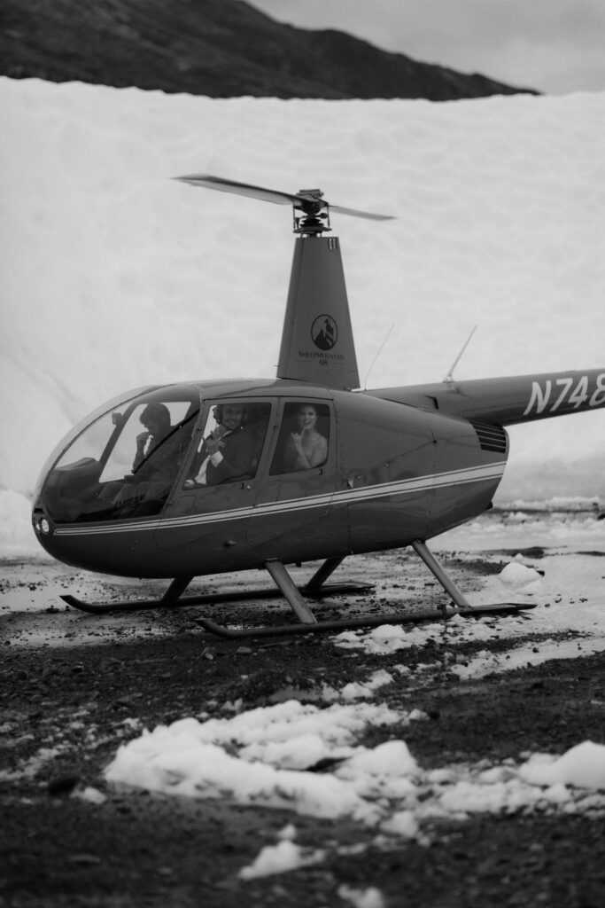 Bride and groom in helicopter on Matanuska Glacier in Sutton Alaska