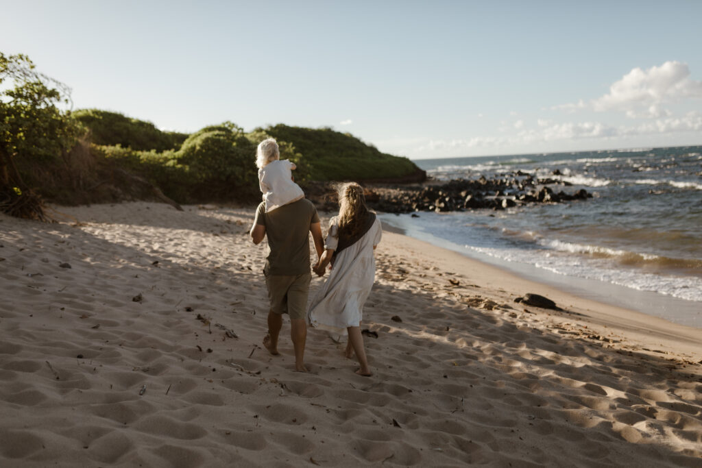Family walking on the beach at golden hour in Maui. Hawaii