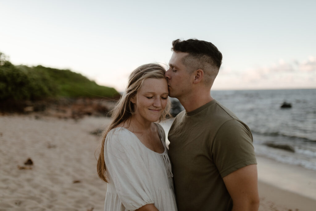 Couple embracing on beach in Maui Hawaii