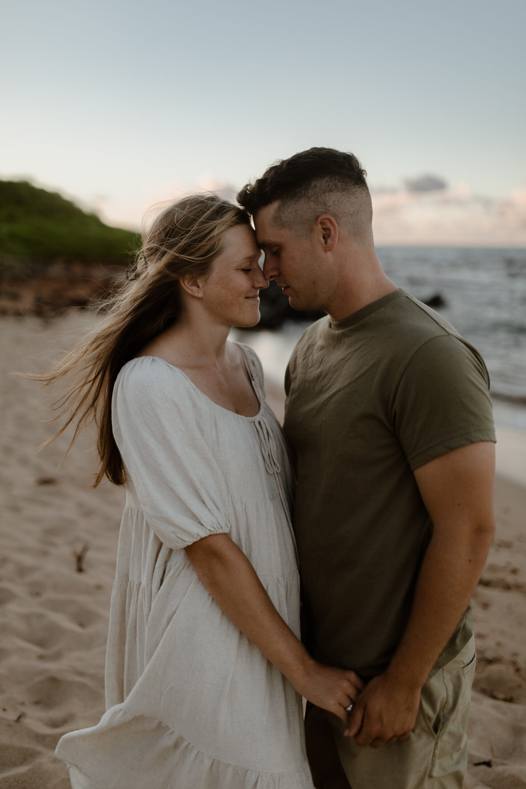 Couple embracing on beach in Maui Hawaii