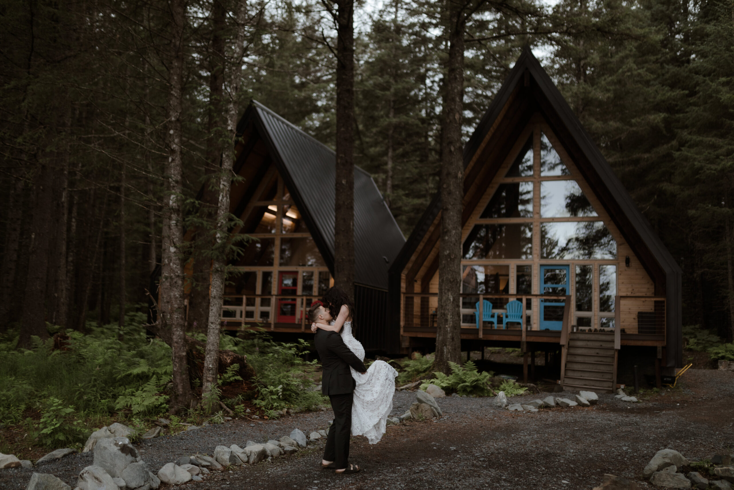 Bride and groom dancing in front of the Salted Roots Cabins in Seward, Alaska